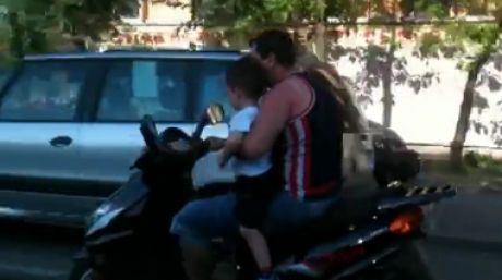 INCONȘTIENȚĂ: Copil plimbat în brațe pe un scuter VIDEO - adultinconstient24374700-1336127975.jpg