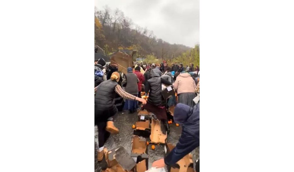 Zeci de oameni s-au înghesuit să adune portocalele împrăștiate dintr-un TIR răsturnat