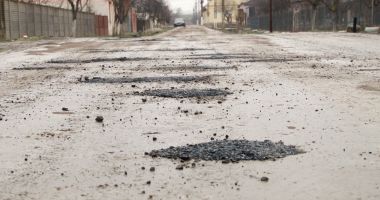 Stire din Eveniment : Sătul să aștepte după reparațiile primăriei, un bărbat a astupat singur gropile de pe stradă cu asfalt